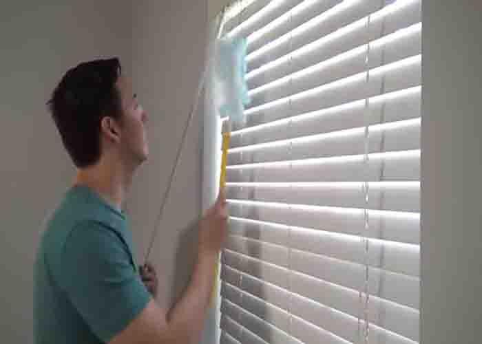Cleaning the blinds using Swiffer duster