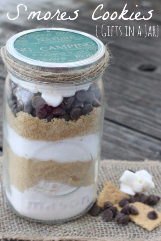 Mason jar of s'mores cookie mix layered with graham crumbs, chocolate chips and mini marshmallows on top