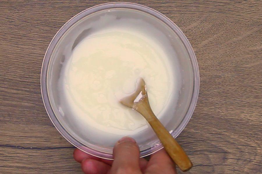Stirring the simple two ingredient glaze for cinnamon bread in a bowl