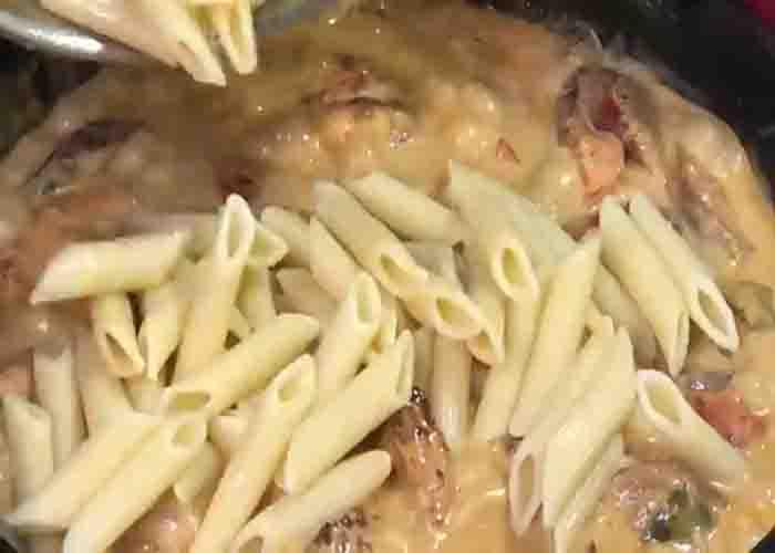 Mixing the pasta and the cajun shrimp sauce