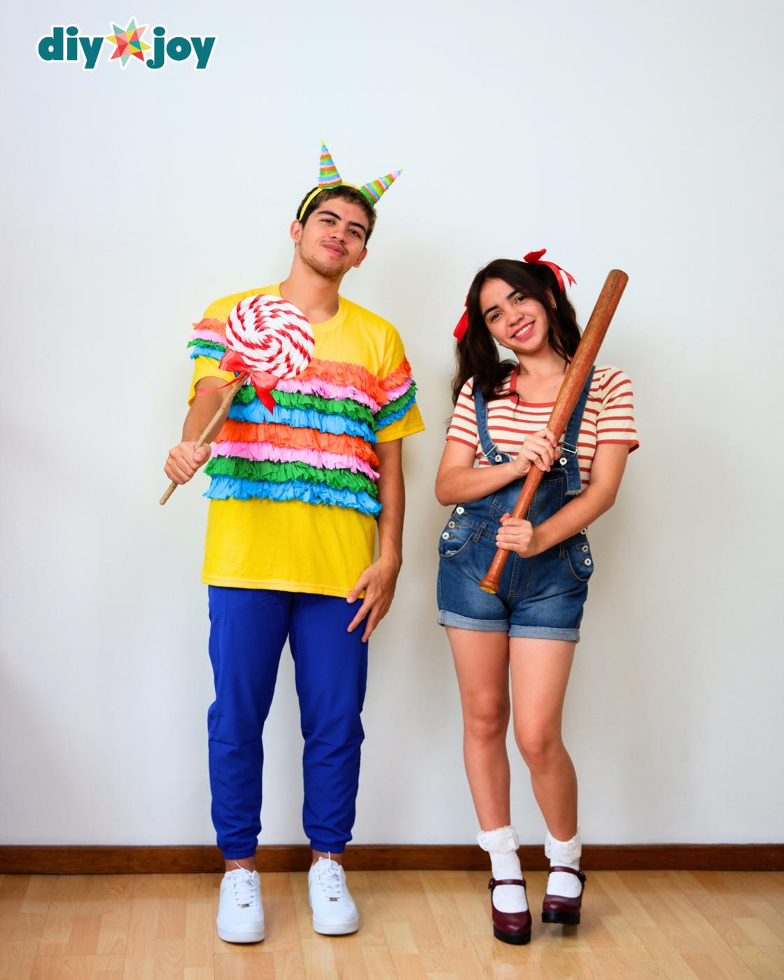 Easy Halloween Costumes - a man in a fringe shirt and headband holding a swirl lollipop, beside a woman in overalls.