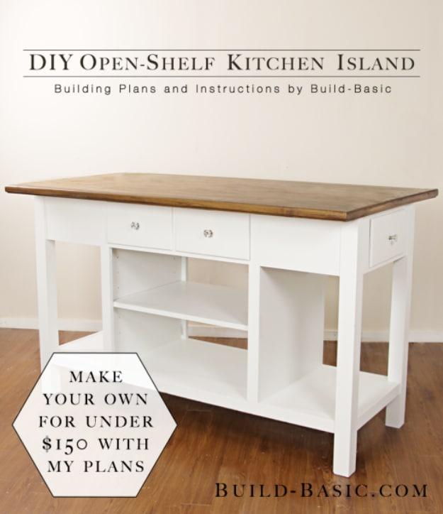 White kitchen island with three drawers, open lower shelving compartments and a stained wood plank top, on a wood floor