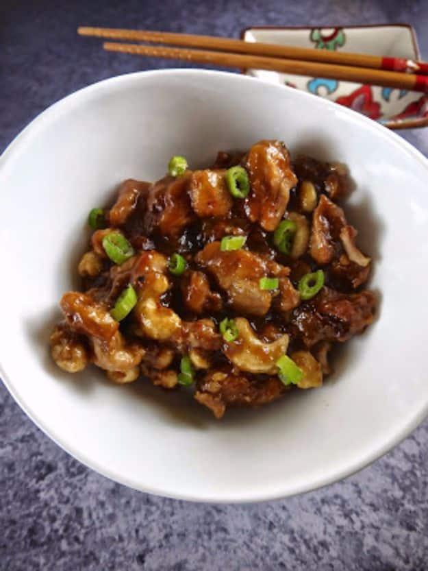 Paleo crock pot cashew chicken with whole cashews in a glossy sauce, a healthy slow cooker dinner idea