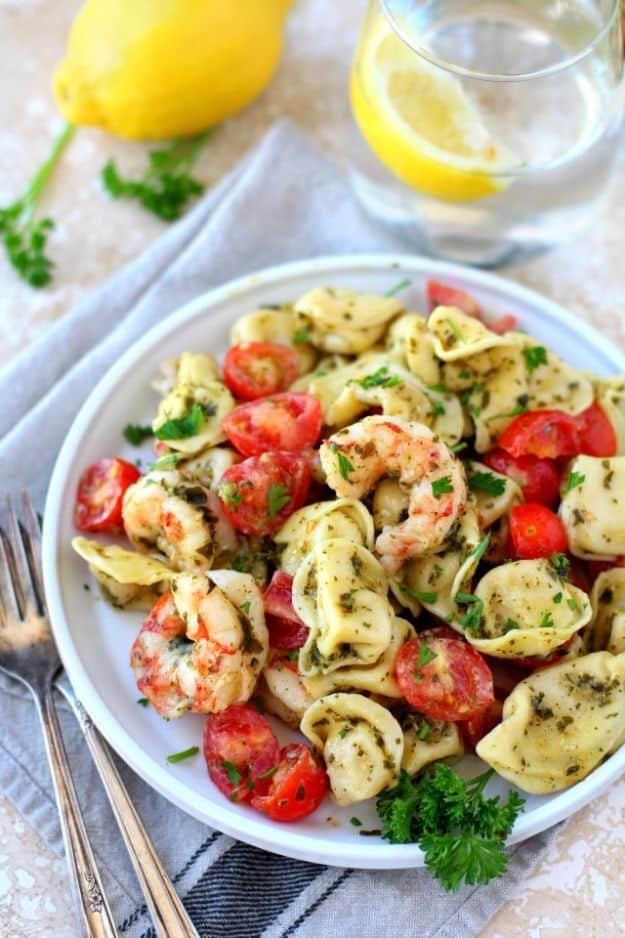 Easy pesto shrimp tortellini salad with cheese tortellini, shrimp and ripe tomatoes tossed in basil pesto