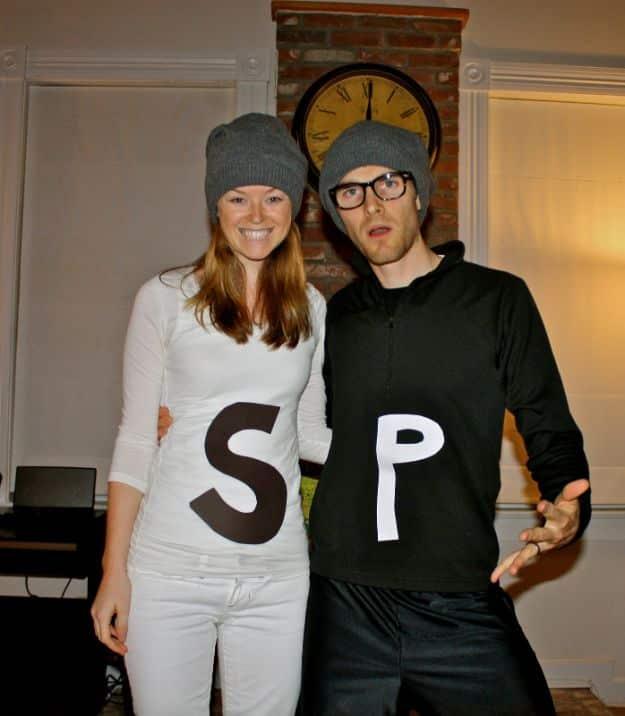 Salt and pepper couples costume with one person in all white and one in all black, both in gray knit beanies
