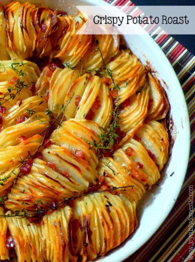 Crispy potato roast with thin russet slices standing on edge in a round dish with pancetta and thyme