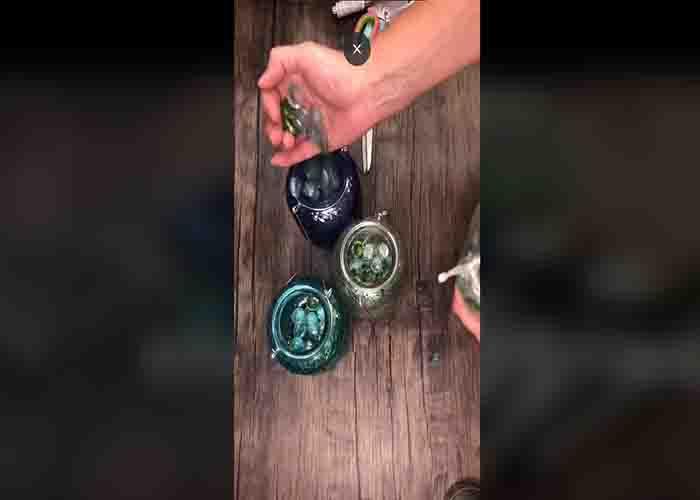 Adding the marble gems to the glass jar
