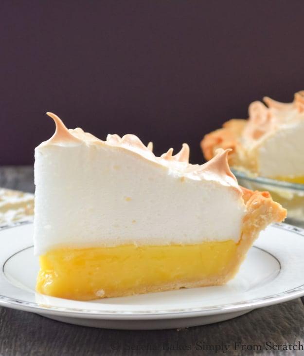 Lemon meringue pie with tall toasted meringue peaks over a bright yellow lemon filling in a flaky crust