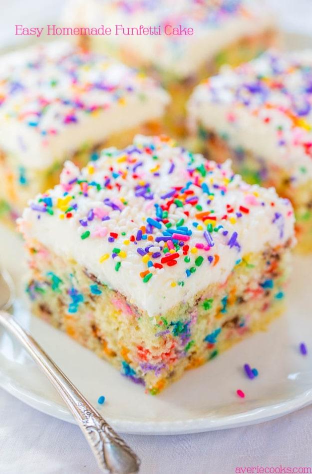Square slice of homemade funfetti birthday cake with white vanilla buttercream and rainbow sprinkles on a plate
