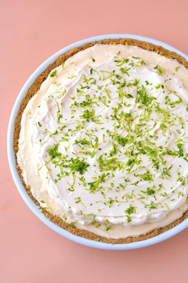 No bake key lime pie topped with whipped cream and lime zest in a buttery cookie crumb crust, an easy no bake dessert