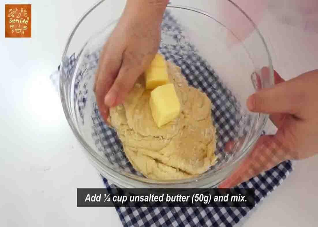 Folding the dough with butter for the garlic and scallions bread