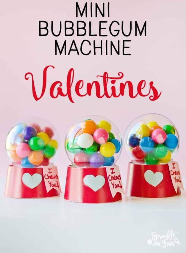 A mini bubblegum machine made from a clear ornament and a red paper cup filled with gumballs for Valentine's Day