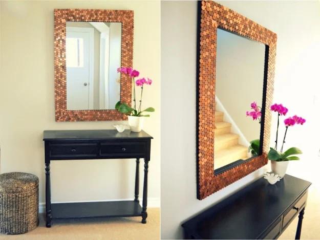 Penny tiled mirror with a wide copper coin frame, shown straight on and at an angle above a dark console table