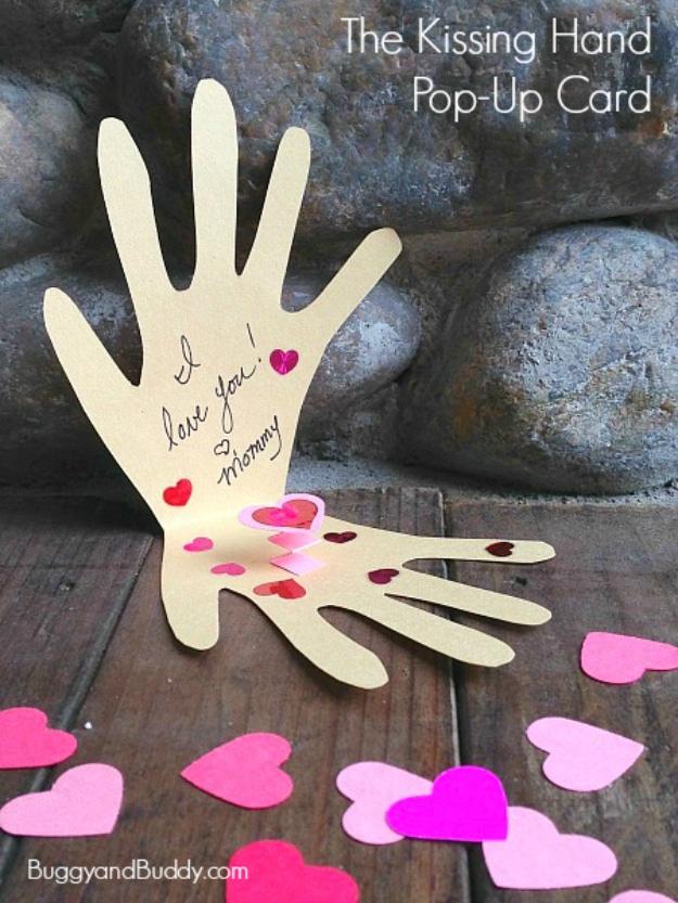 Kissing Hand pop up card cut from folded construction paper with a small heart on the open paper palm