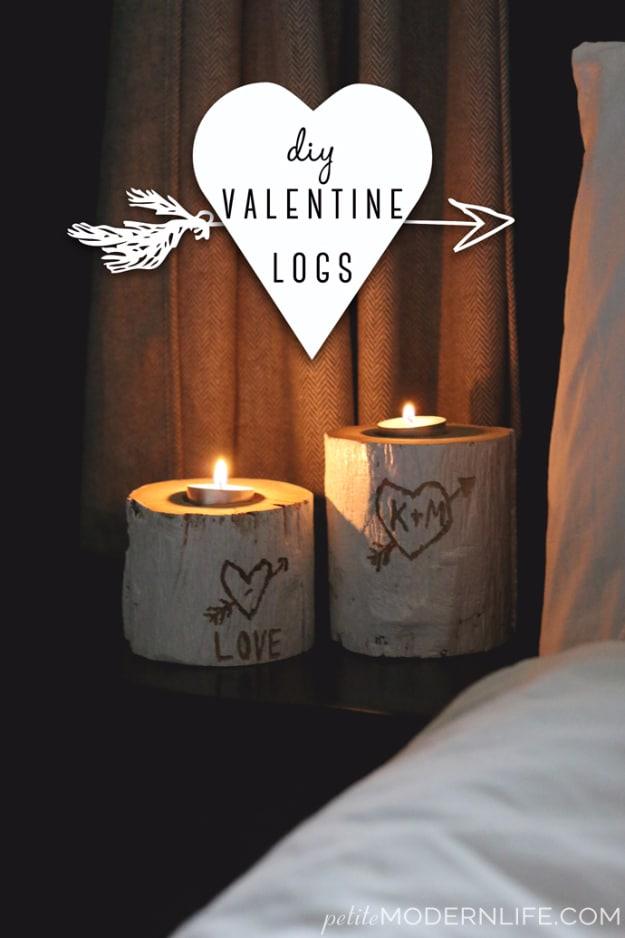 Wood log slices painted with small red hearts stacked on a shelf as rustic Valentine decor gifts on a craft table