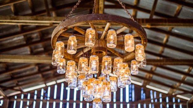 Wagon Wheel Chandelier Made With Mason Jars, a rustic outdoor element, simple enough for a first attempt at the idea
