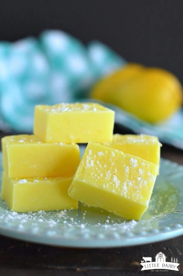 Bright yellow lemon fudge cut into small squares on parchment, an easy five minute no chocolate fudge recipe