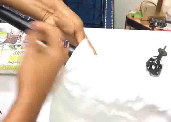 Inserting the curtain rod through the sheets