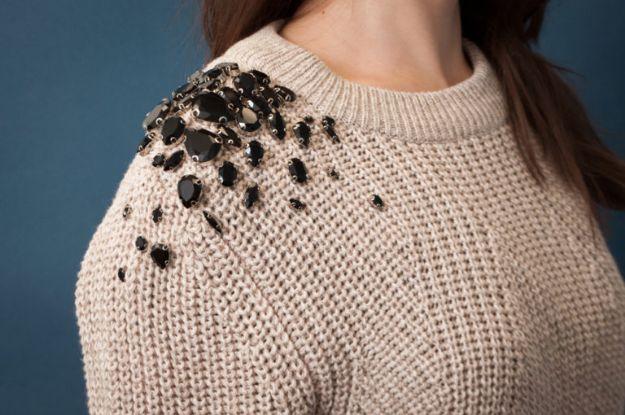 DIY clothes for winter, a beige ribbed knit sweater with black faceted jewels clustered across one shoulder
