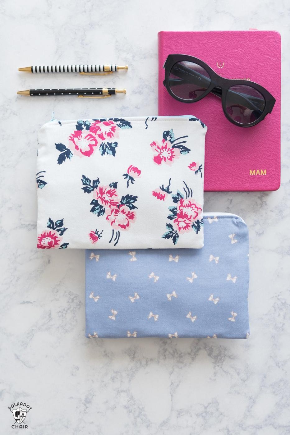 A lined zip pouch in bright cotton with a yellow zipper, sitting open on a cutting mat beside a pile of fabric scraps