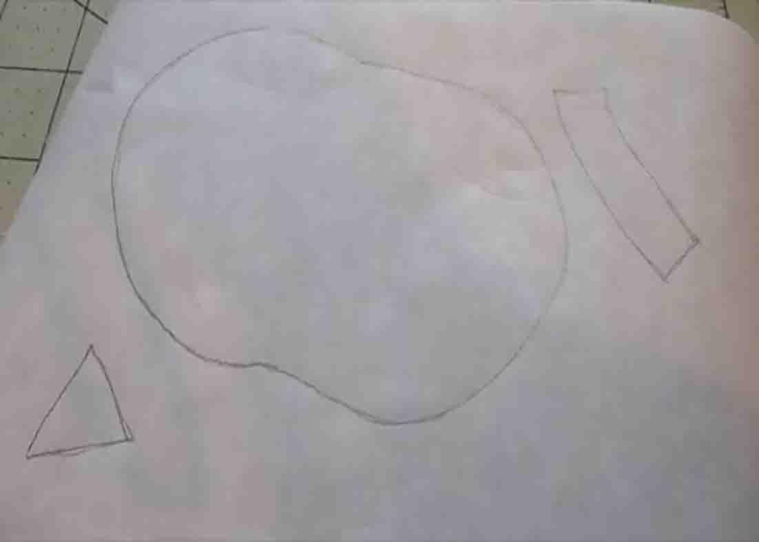 Tracing the owl pattern from the paper to make the appliqued owl potholder