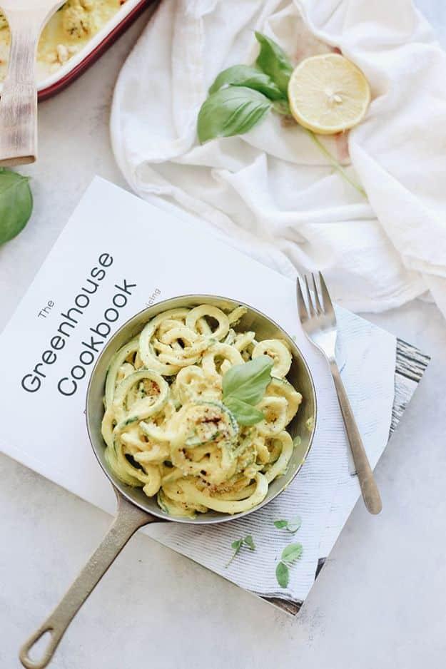 Spiralized zucchini mac and cheese in a small pan with a vegan cashew sauce and a toasted oat crumb topping