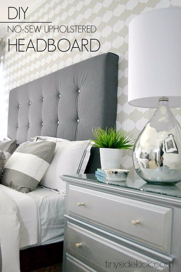 DIY upholstered headboard with a high end look, a gray button tufted headboard beside a silver lamp and painted nightstand
