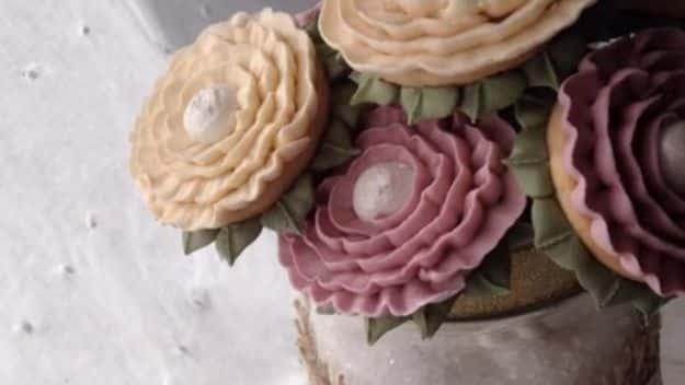 DIY cookie bouquet of decorated cookies on sticks, arranged in a container like a bunch of cut flowers