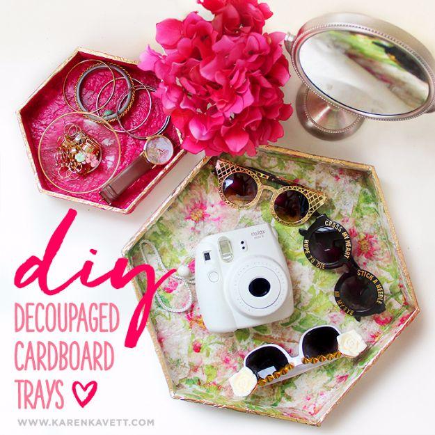 Cardboard craft hexagon trays decoupaged in floral napkin print holding sunglasses and a camera beside a pink tray