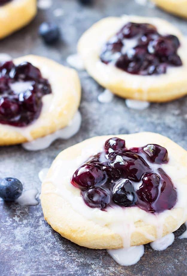 Blueberry cream cheese danishes made from flattened canned biscuits and finished with a sugar glaze recipe worth making twice