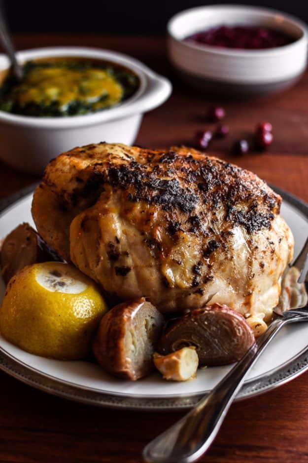 Slow cooker turkey breast sliced on a platter with gravy, a healthy crockpot recipe for a small holiday