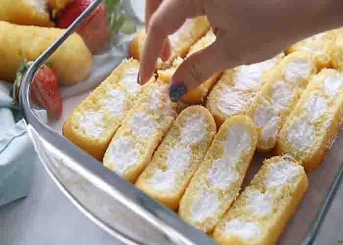 Layering the twinkies to the bottom of the casserole dish
