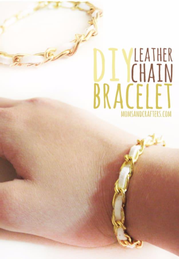 A bracelet of tan leather cord woven through a silver curb chain, coiled on grey stone, handmade shop jewelry