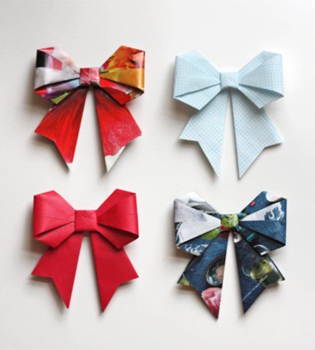 Origami bows folded from magazine pages and patterned paper in red, blue and pale grid print on white
