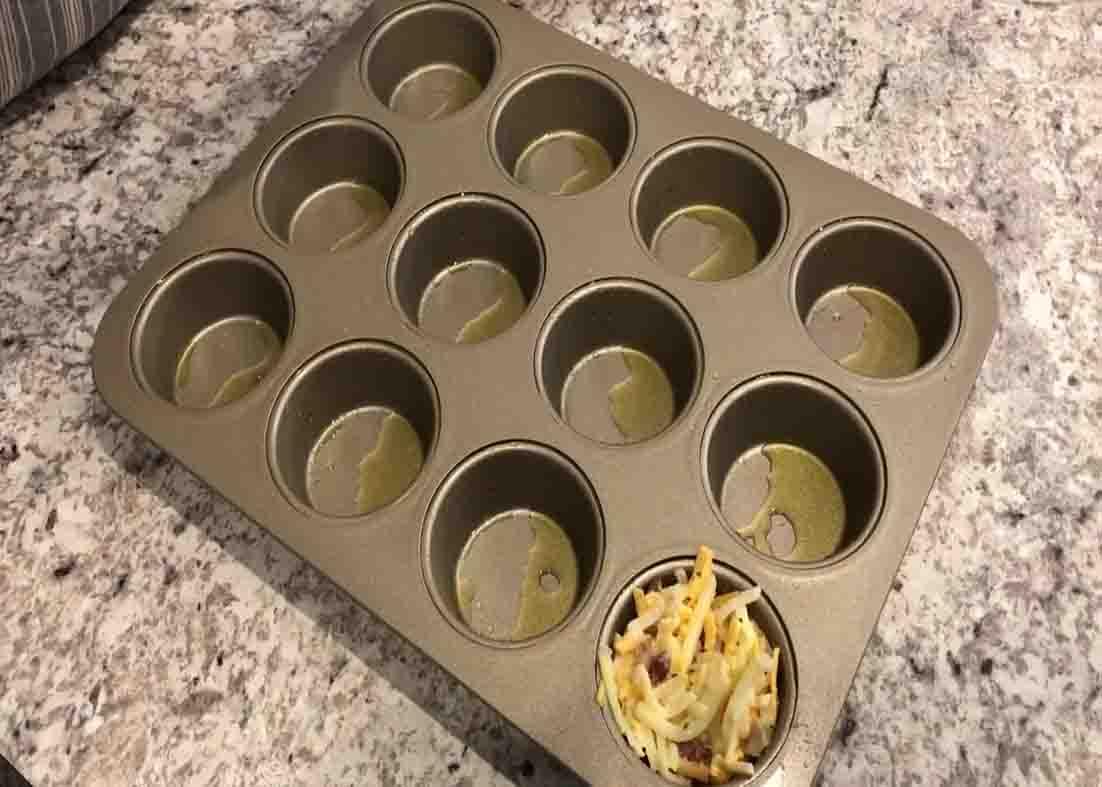 Distributing the hash brown mixture to the muffin cups