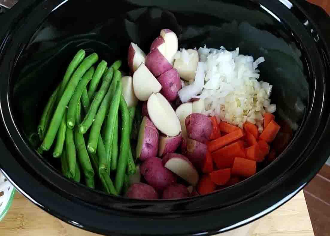 Seasoning the veggies in the slow cooker