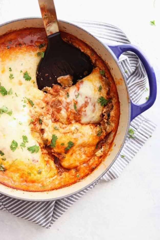 Butternut squash lasagna layered in a dutch oven with thin squash rounds replacing the pasta noodles