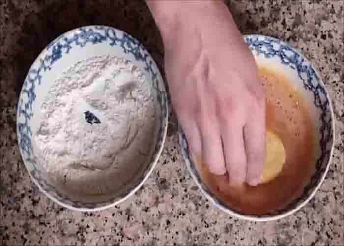 Dredging the Spanish potatoes before cooking