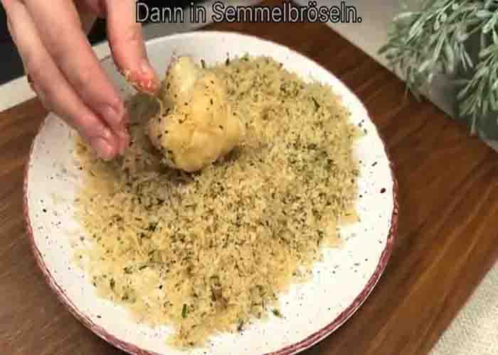 Dredging the cauliflower with breadcrumbs mixture