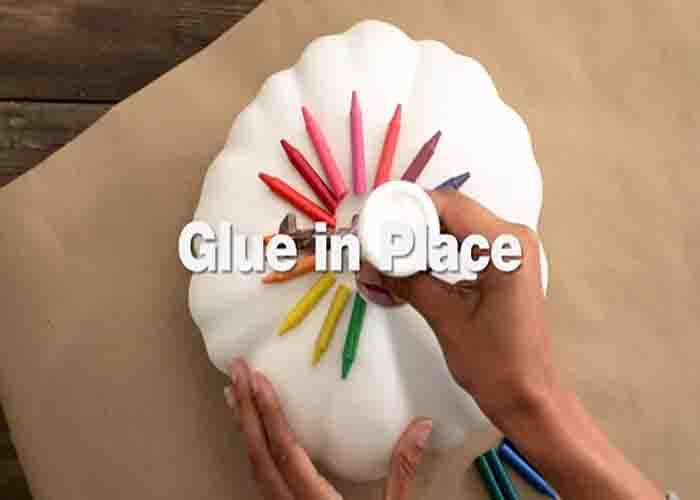 Gluing the crayons to the pumpkin