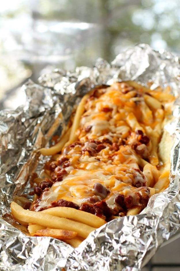 Campfire chili cheese fries loaded into a foil packet for an indulgent camping dinner or shared side