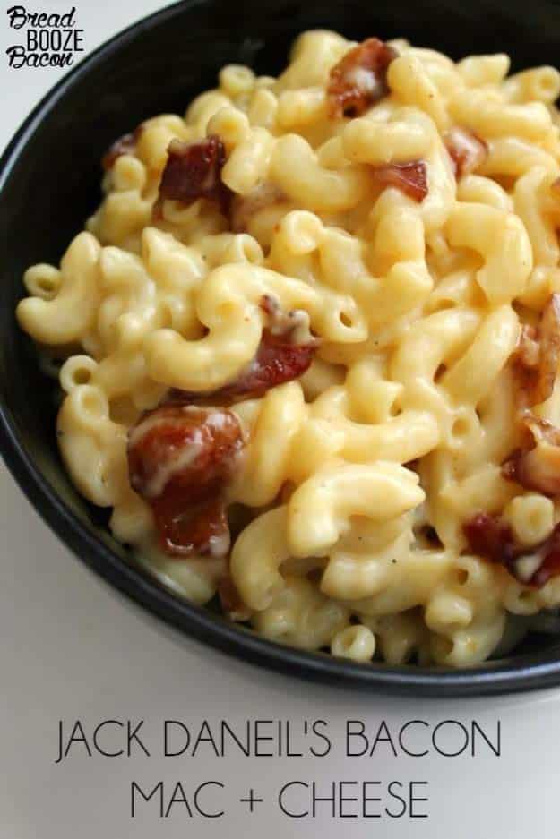 Jack Daniels bacon mac and cheese in a black bowl with elbow macaroni and crisp torn pieces of bacon