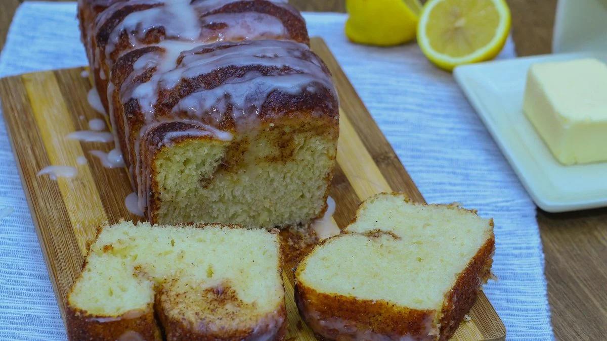 Copycat Dollywood cinnamon bread loaf glazed and sliced on a wooden board