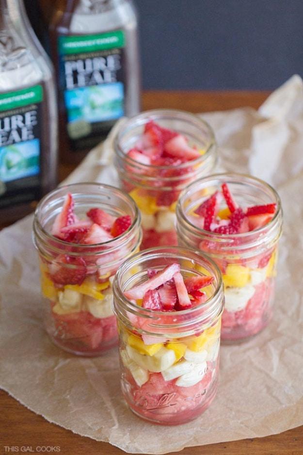 Fresh fruit salad in mason jars with mixed chopped fruit ready as a grab and go snack from the fridge