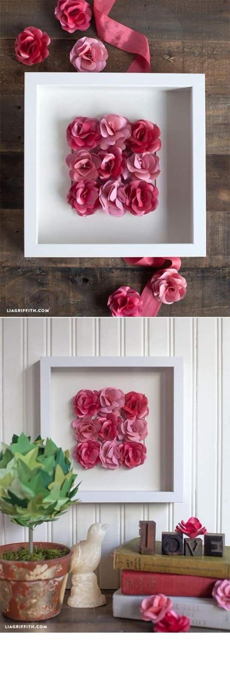Mini paper rose framed artwork, nine small pink paper roses in a white shadow box frame above a shelf