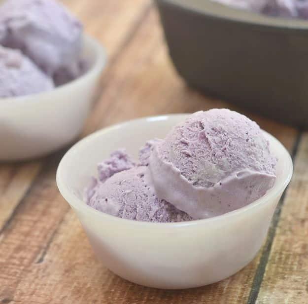 Ube macapuno ice cream in bright purple scoops with coconut strips, a Filipino no churn frozen dessert