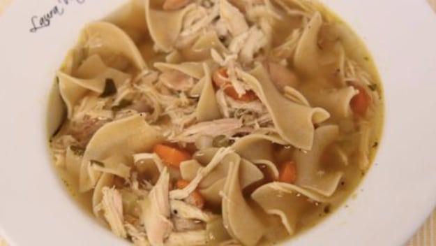 Homemade chicken noodle soup with roasted chicken, egg noodles, carrots and celery in a deep bowl for a comforting dinner