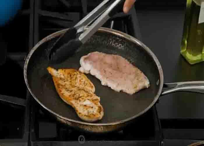 Browning the chicken breasts for the pizza chicken recipe
