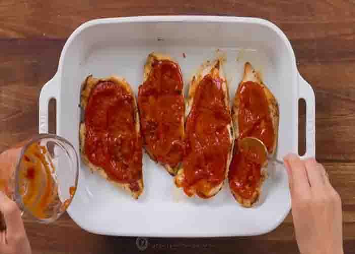 Assembling the pizza chicken dish
