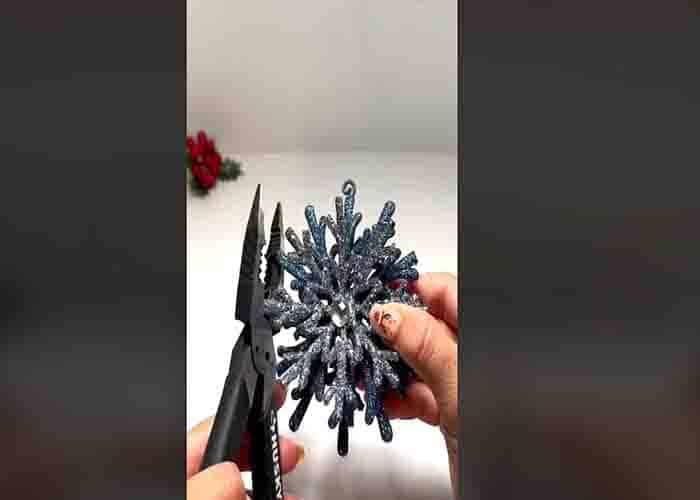 Clipping the edges of the snowflake ornament for the floating candle decoration